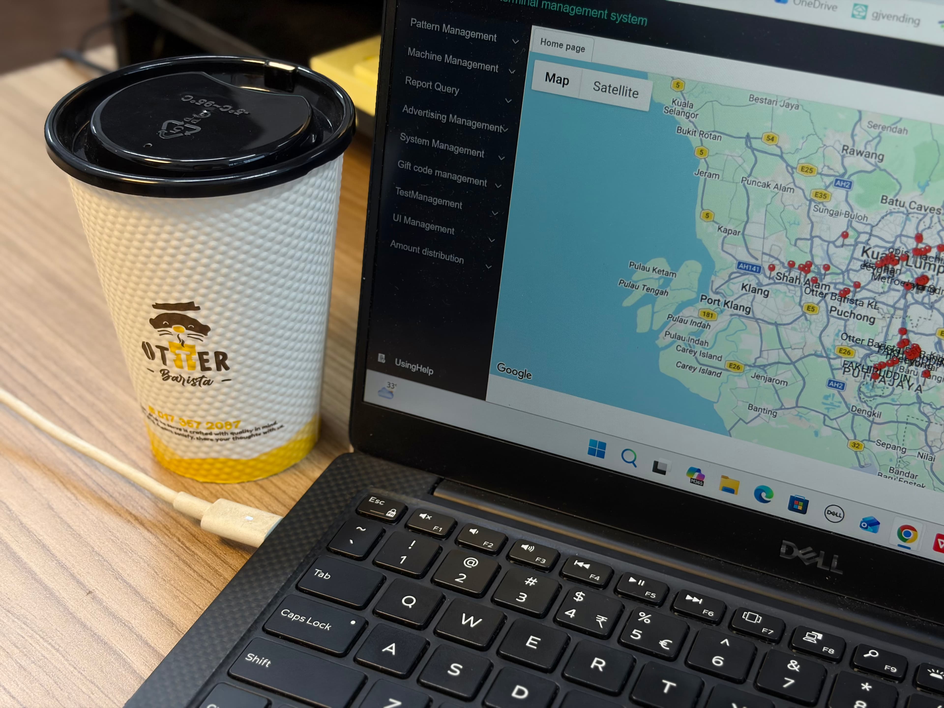 The Otter cloud dashboard on a laptop on an office desk, a coffee cup beside it
